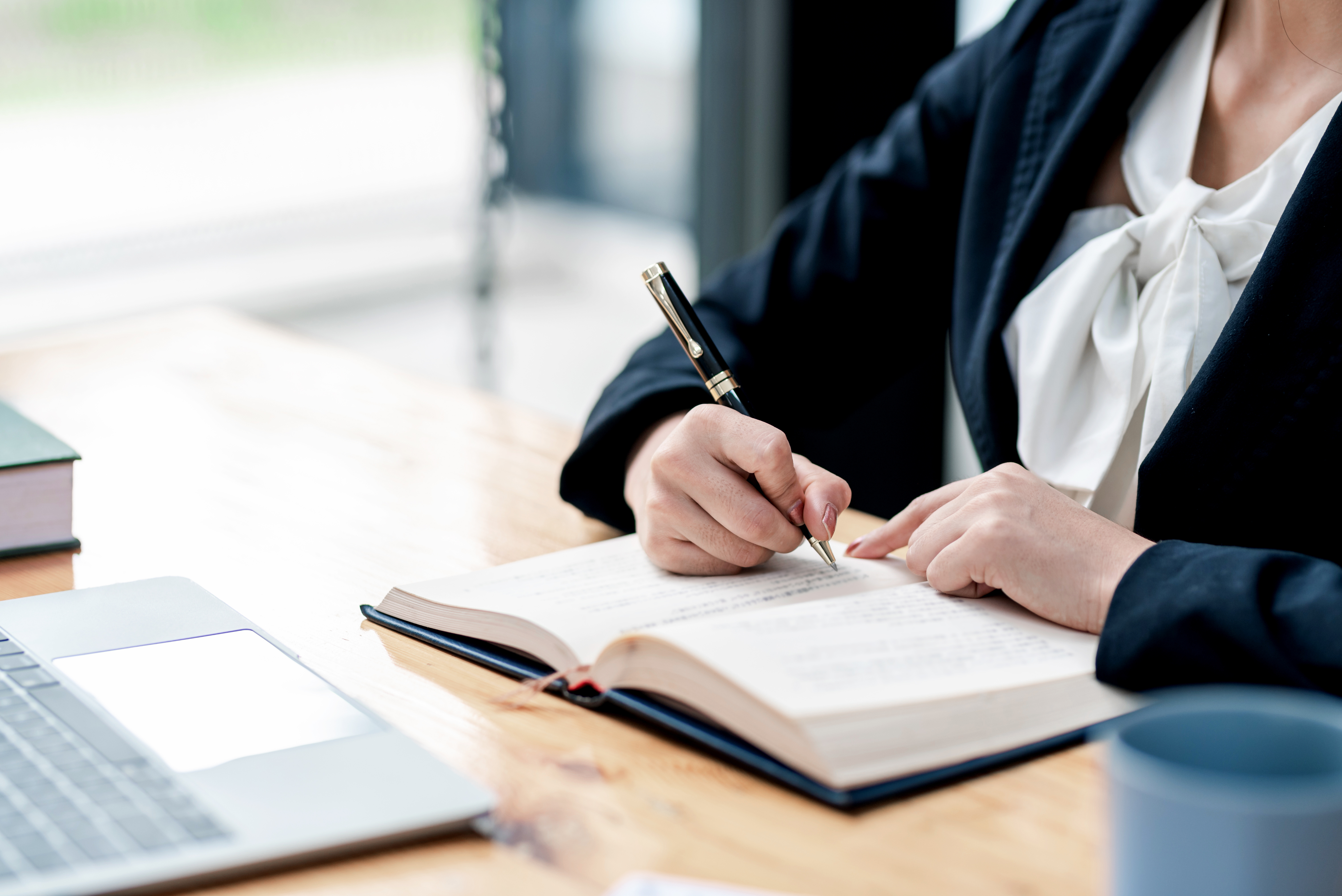 Professional proofreader reviewing a manuscript at a desk